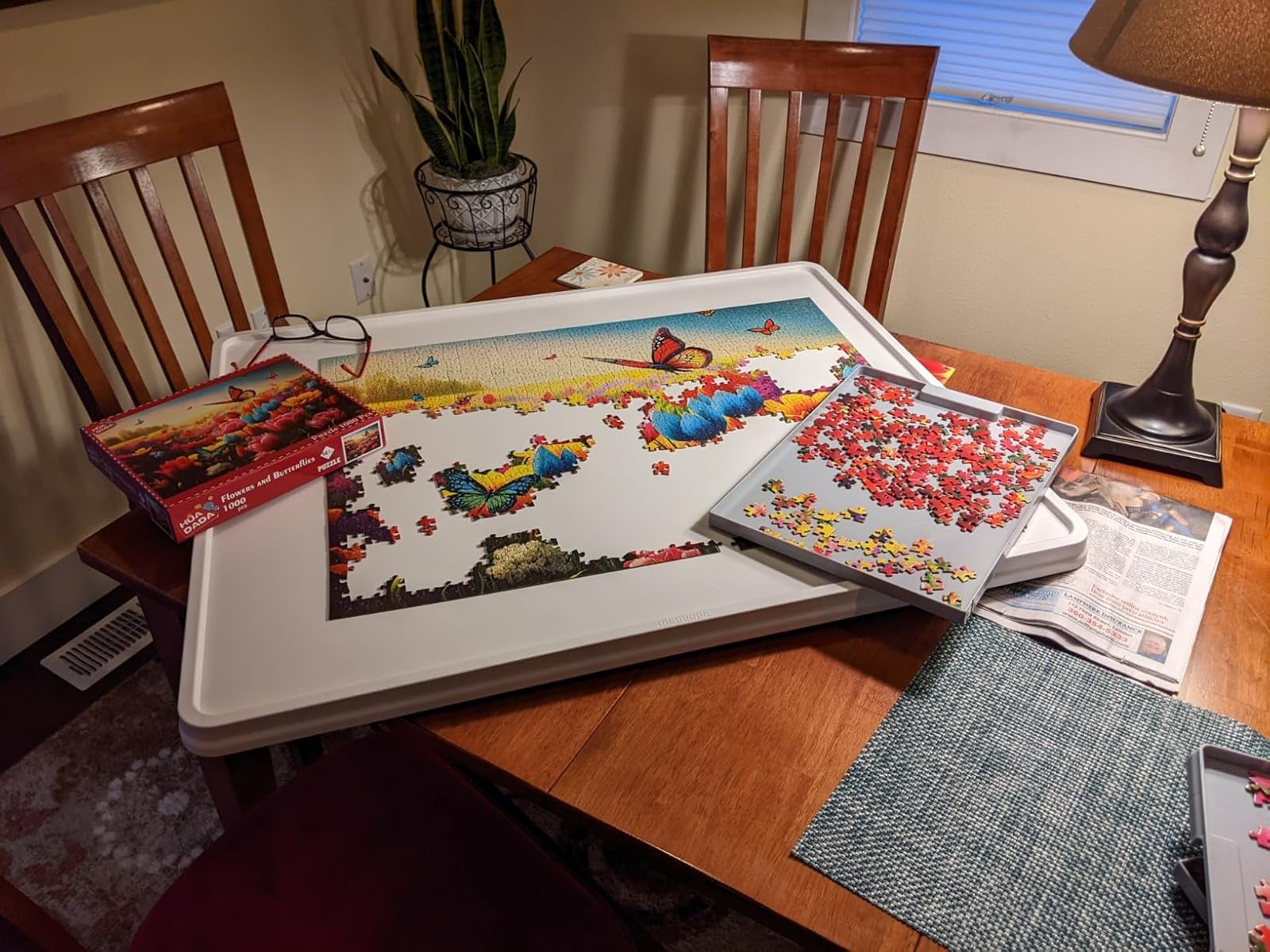Customer review photo of 1500PCS whiteboard puzzle board with grey drawers in use on a wooden dining table