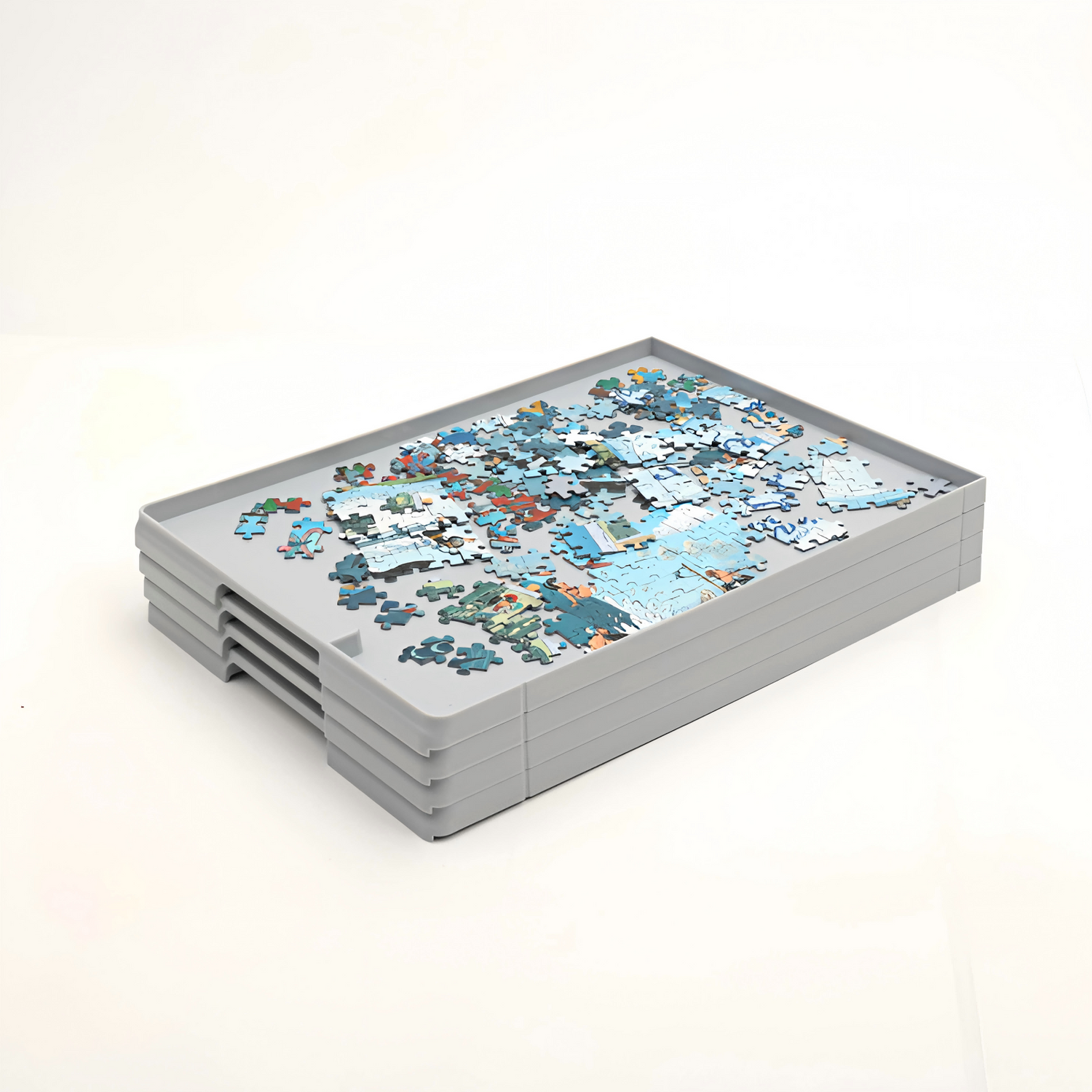 Stacked gray puzzle sorting drawers filled with assorted blue jigsaw pieces, designed for organized storage by color or shape.