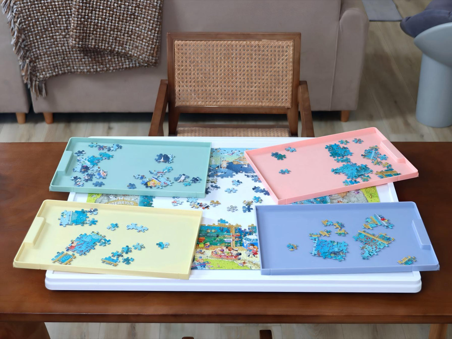 Overhead view of a 1000-piece whiteboard puzzle table with colorful sorting drawers and bright jigsaw pieces in a cozy living room