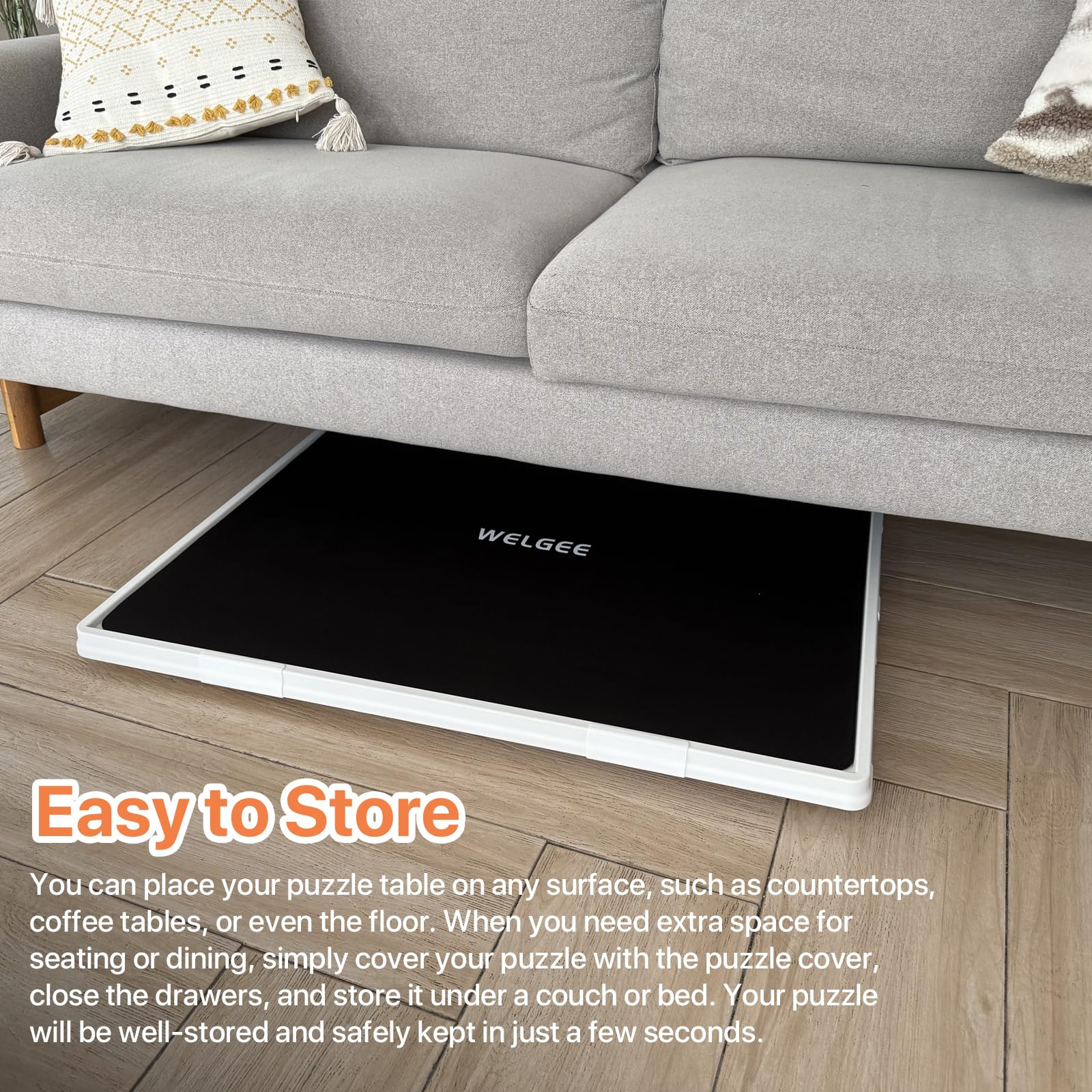 Playboda puzzle board stored under a sofa with protective cover, showing its slim profile and space-saving design for easy storage between puzzle sessions.