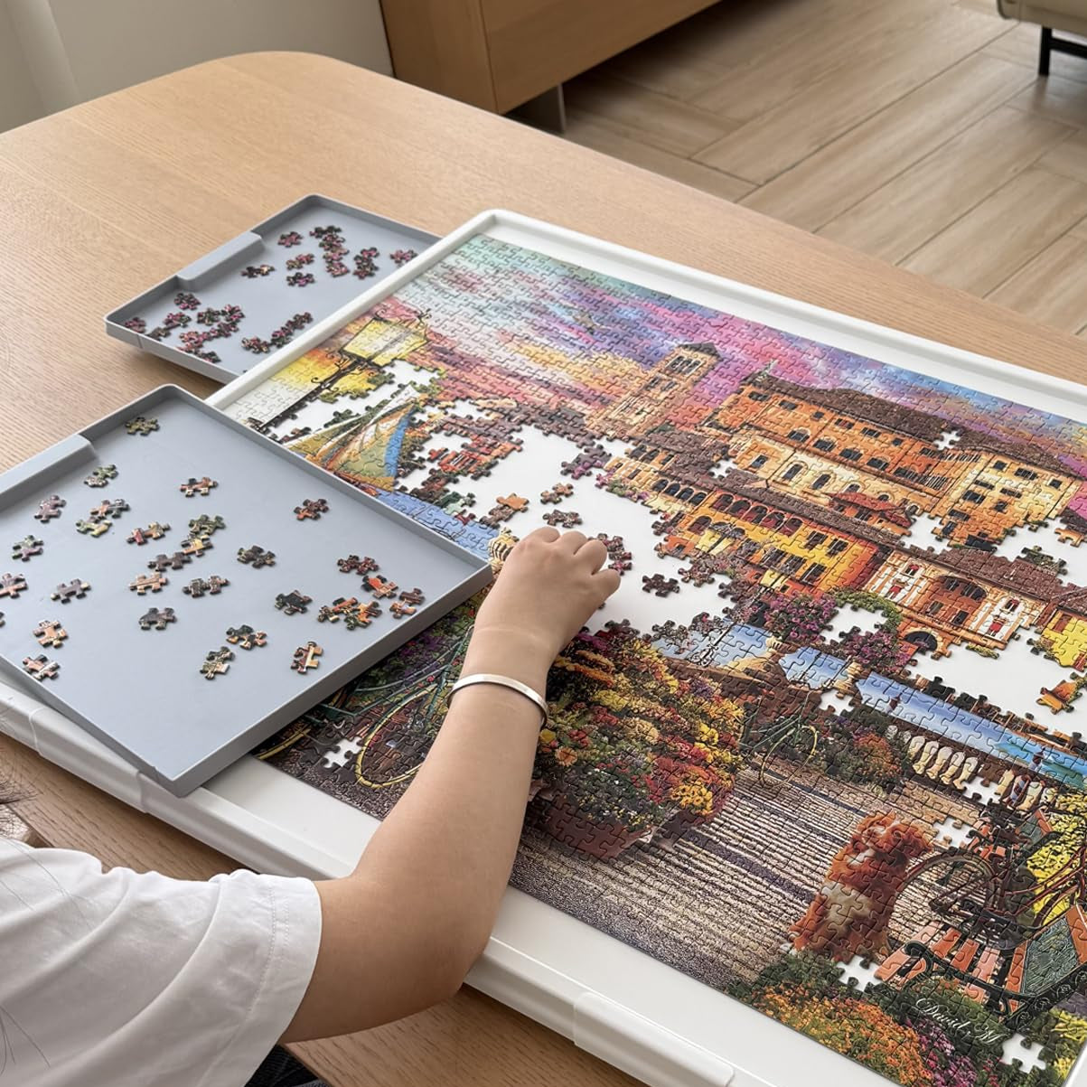 Playboda puzzle board with a large warm white work surface, making jigsaw puzzle pieces easier to see and sort, with built-in drawers for organized puzzling.