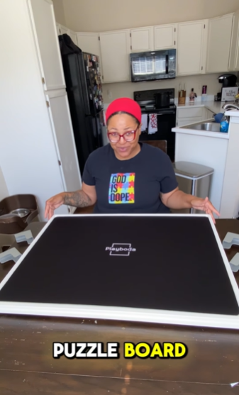 Customer unboxing Playboda puzzle board in a kitchen setting